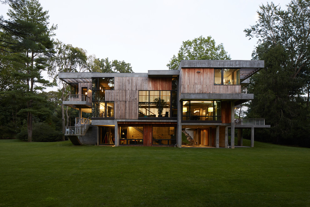 Design ideas for an expansive contemporary three-storey exterior in New York with a flat roof and wood siding.