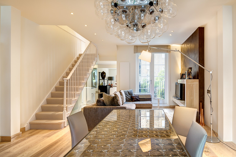 Design ideas for a medium sized contemporary formal open plan living room in London with brown walls, light hardwood flooring, a standard fireplace, a stone fireplace surround and a freestanding tv.