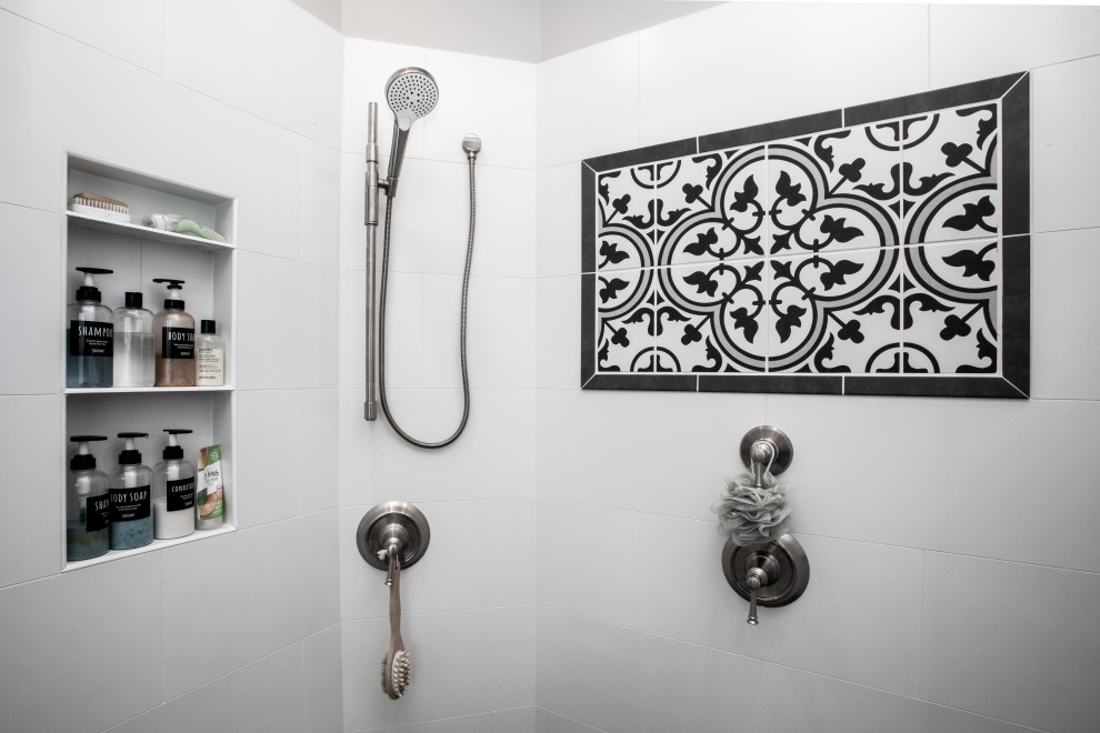 This is an example of a large contemporary ensuite bathroom in New York with freestanding cabinets, black cabinets, a freestanding bath, an alcove shower, a one-piece toilet, black and white tiles, cement tiles, grey walls, ceramic flooring, a built-in sink, granite worktops, black floors, a hinged door, beige worktops, an enclosed toilet, double sinks, a built in vanity unit, a vaulted ceiling and tongue and groove walls.