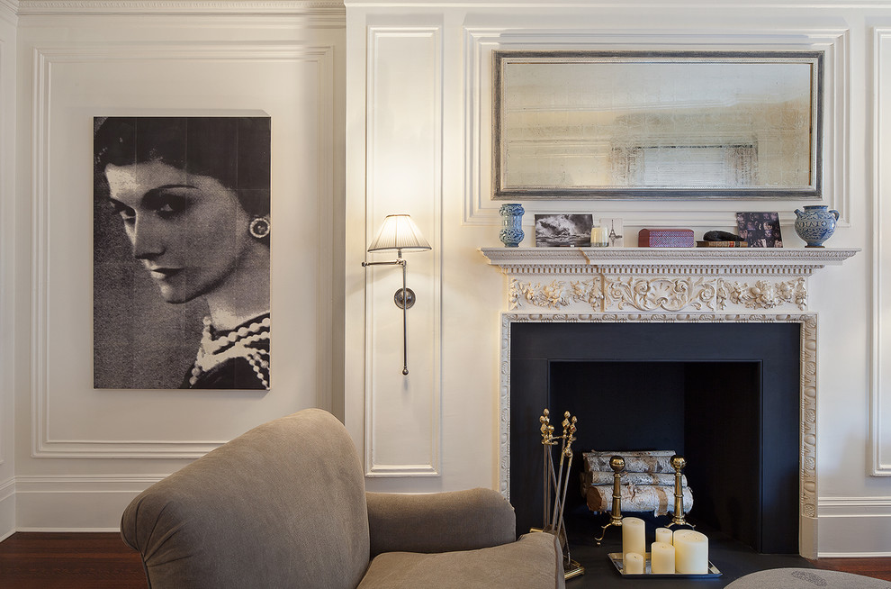 This is an example of a traditional living room in New York with white walls and a standard fireplace.