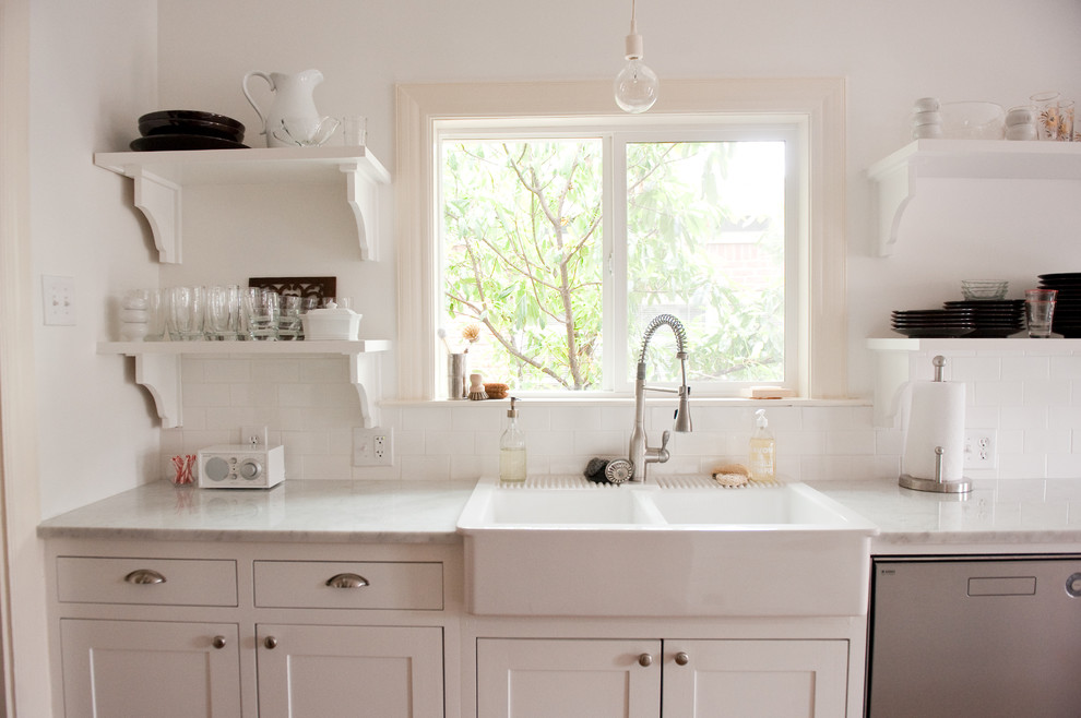 Inspiration for a traditional kitchen in Dallas with subway tile splashback, a drop-in sink, open cabinets, white cabinets, marble benchtops and white splashback.