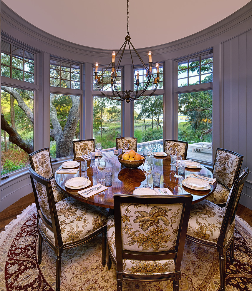 Traditional dining room in Charleston with grey walls and dark hardwood floors.