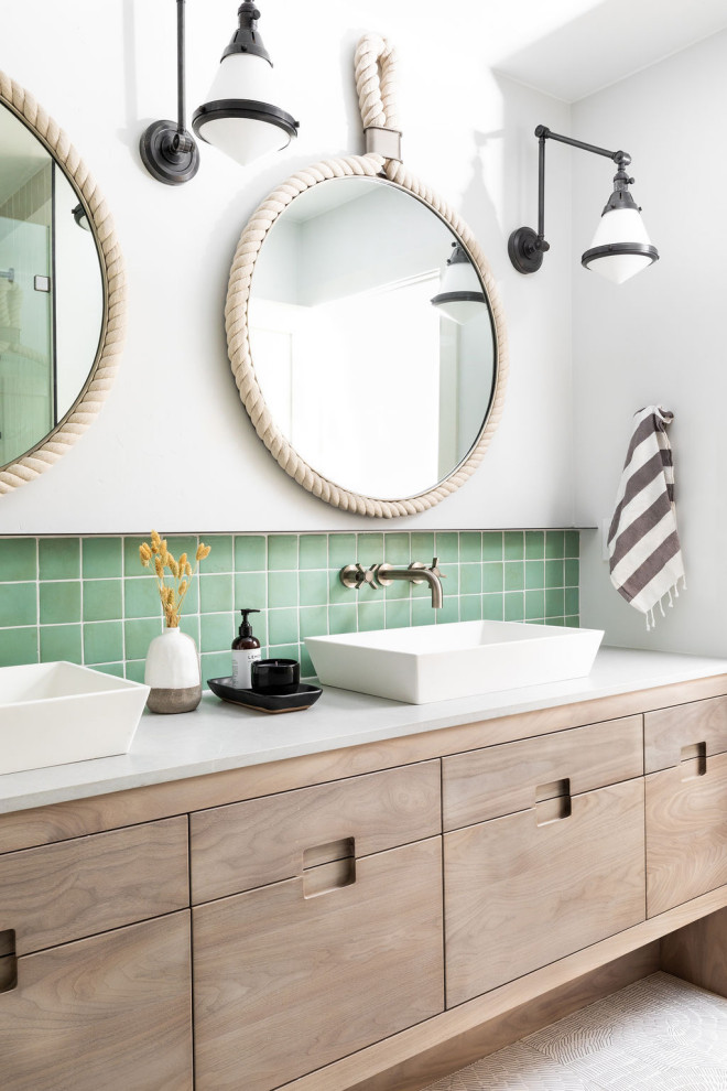 This is an example of a nautical family bathroom in Sacramento with flat-panel cabinets, medium wood cabinets, green tiles, white walls, a vessel sink, engineered stone worktops, beige floors, white worktops, double sinks and a built in vanity unit.
