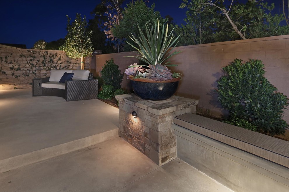 Design ideas for a mid-sized mediterranean backyard patio in Orange County with a container garden, stamped concrete and no cover.
