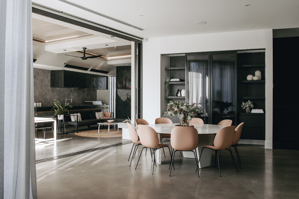 Contemporary dining room in Adelaide with white walls, concrete floors and grey floor.