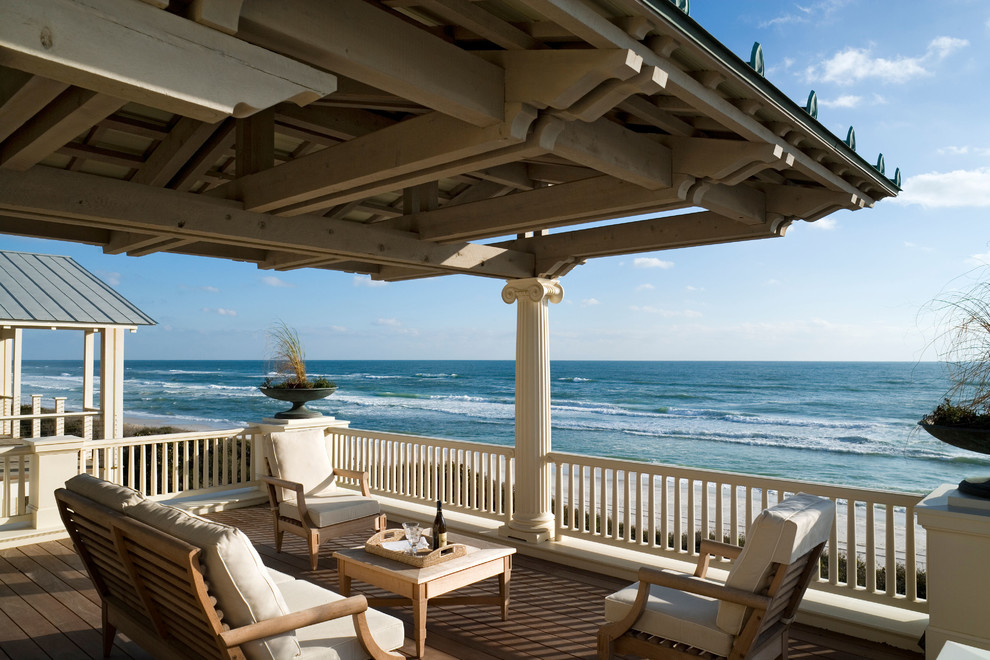 Beach style backyard deck photo in New York with a roof extension