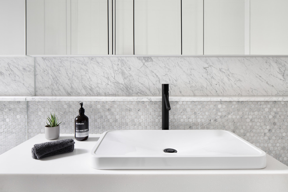 Design ideas for a mid-sized contemporary bathroom in Melbourne with flat-panel cabinets, white cabinets, a drop-in tub, black and white tile, gray tile, ceramic tile, ceramic floors, engineered quartz benchtops, grey floor and white benchtops.