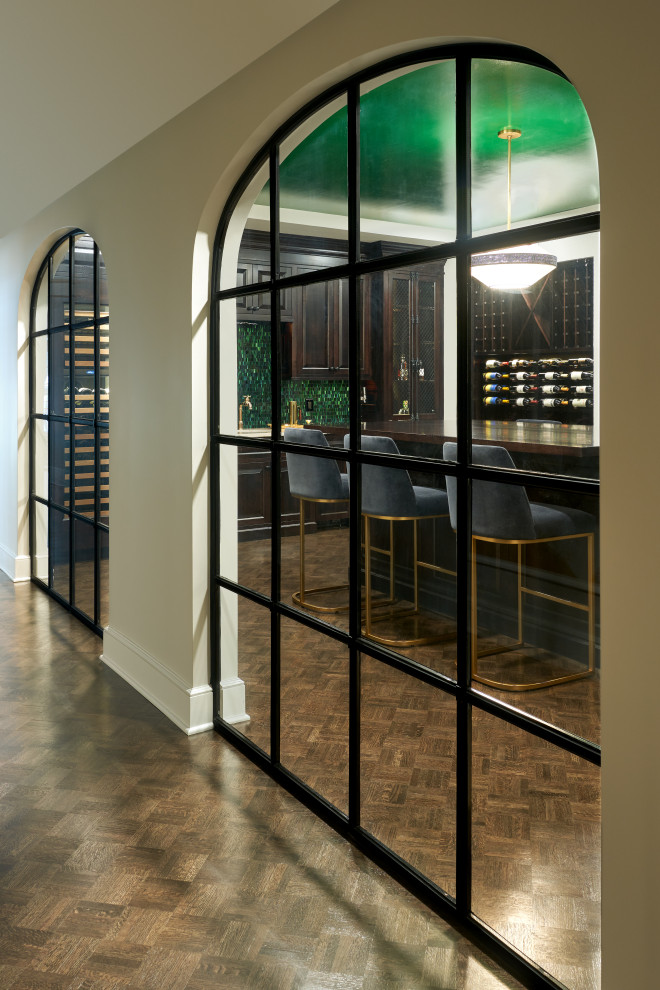 Inspiration for a large transitional wine cellar in Cleveland with dark hardwood floors, storage racks and brown floor.
