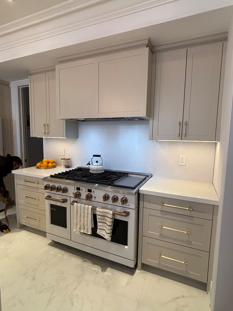 Mid-sized transitional l-shaped porcelain tile, white floor and coffered ceiling eat-in kitchen photo in Toronto with an undermount sink, shaker cabinets, beige cabinets, quartz countertops, white backsplash, quartz backsplash, white appliances, an island and white countertops