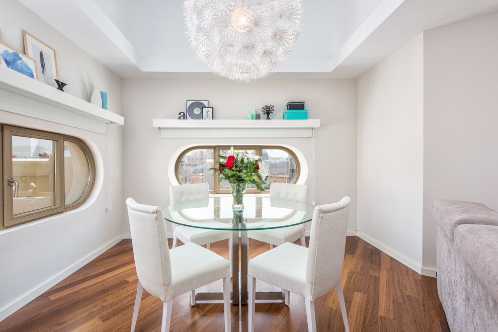 Small contemporary separate dining room in Malaga with white walls, dark hardwood floors and no fireplace.