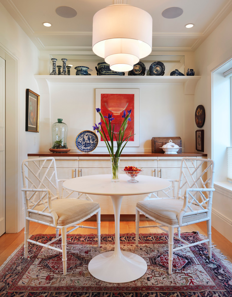 Inspiration for a transitional dining room in Boston with white walls and medium hardwood floors.