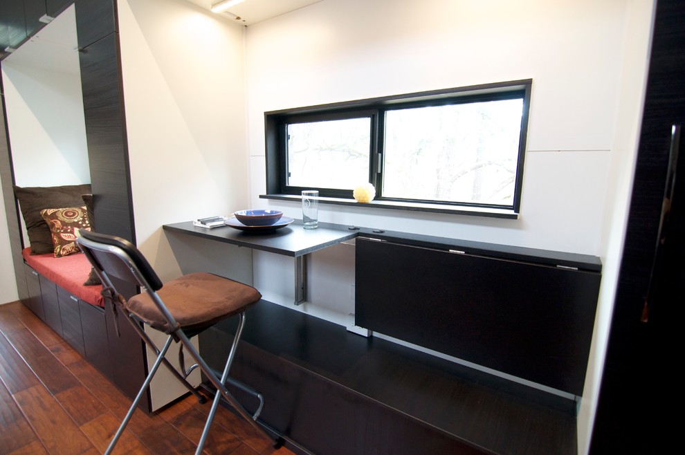 Small minimalist medium tone wood floor dining room photo with white walls
