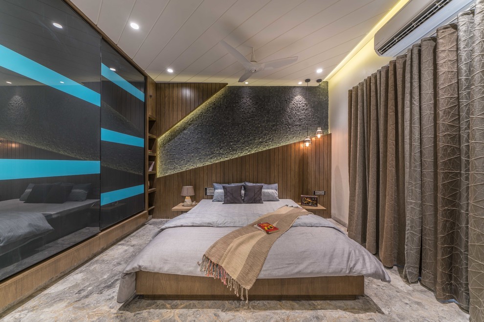 This is an example of a contemporary master bedroom in Hyderabad with beige walls and grey floor.