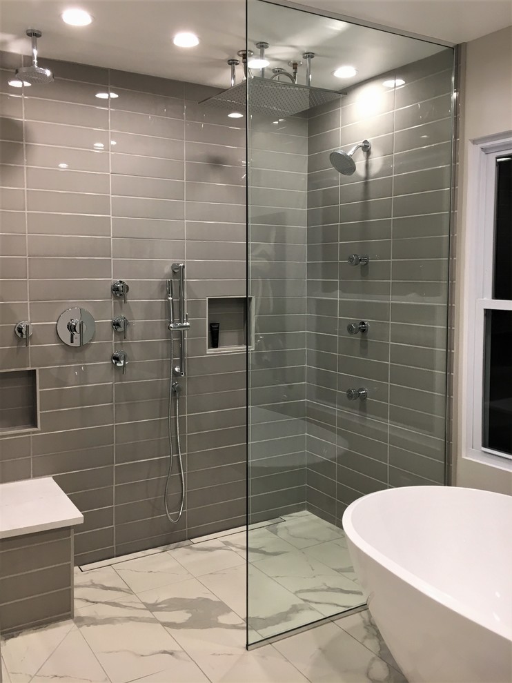 This is an example of a mid-sized modern master wet room bathroom in Other with flat-panel cabinets, brown cabinets, a freestanding tub, a two-piece toilet, gray tile, ceramic tile, grey walls, porcelain floors, a vessel sink, engineered quartz benchtops, multi-coloured floor, an open shower, white benchtops, a niche and a single vanity.
