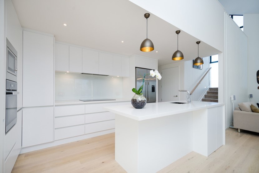 This is an example of a scandinavian kitchen in Auckland with light hardwood floors.