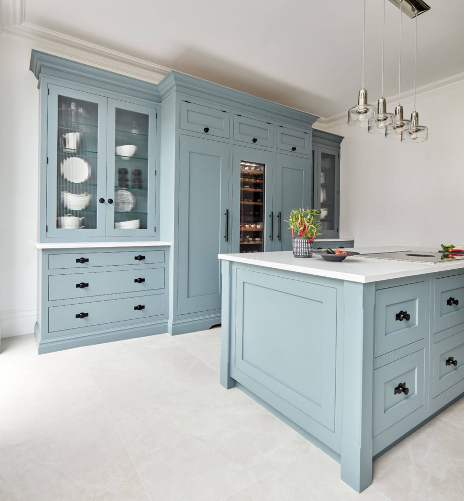 Mid-sized contemporary separate kitchen in Manchester with shaker cabinets, blue cabinets, quartzite benchtops, engineered quartz splashback, panelled appliances, limestone floors, with island, grey floor and white benchtop.