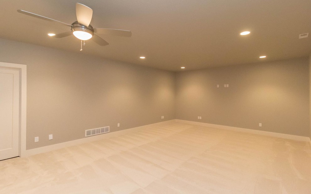 Example of a mid-sized transitional underground carpeted basement design with gray walls and no fireplace