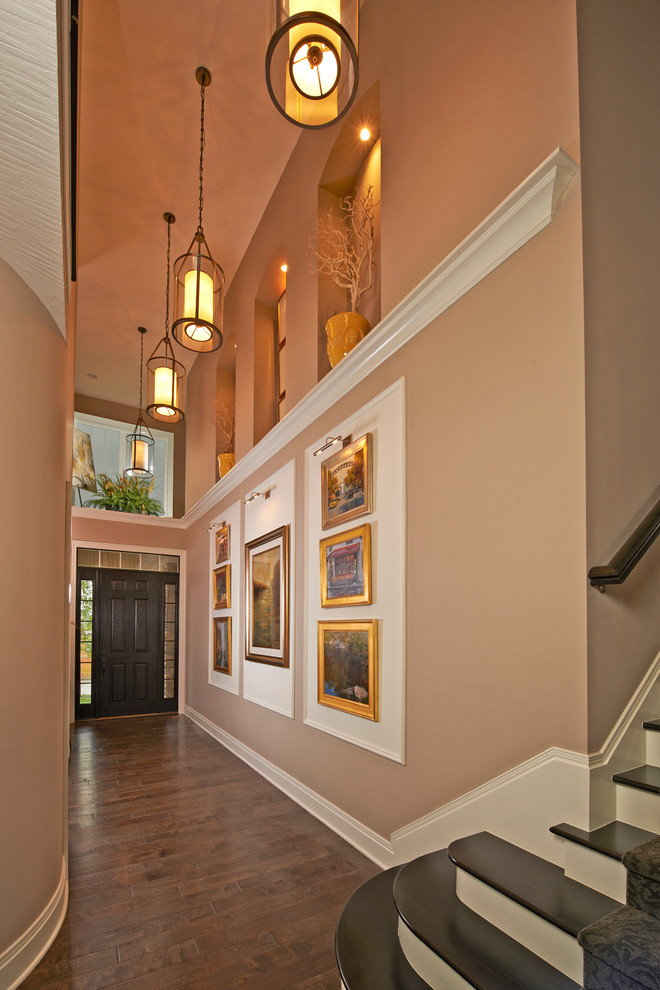 Inspiration for a large contemporary hallway in Columbus with medium hardwood floors and beige walls.