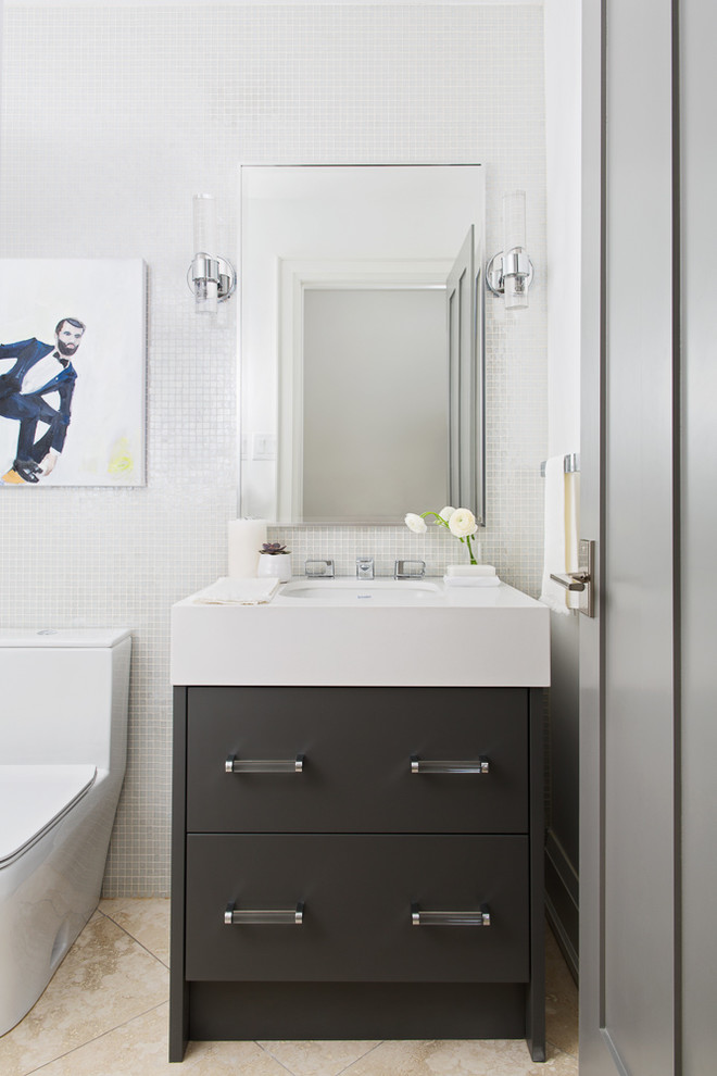 This is an example of a small contemporary bathroom in Toronto with flat-panel cabinets, grey cabinets, a one-piece toilet, white walls, limestone floors, an undermount sink, engineered quartz benchtops, beige floor and mosaic tile.