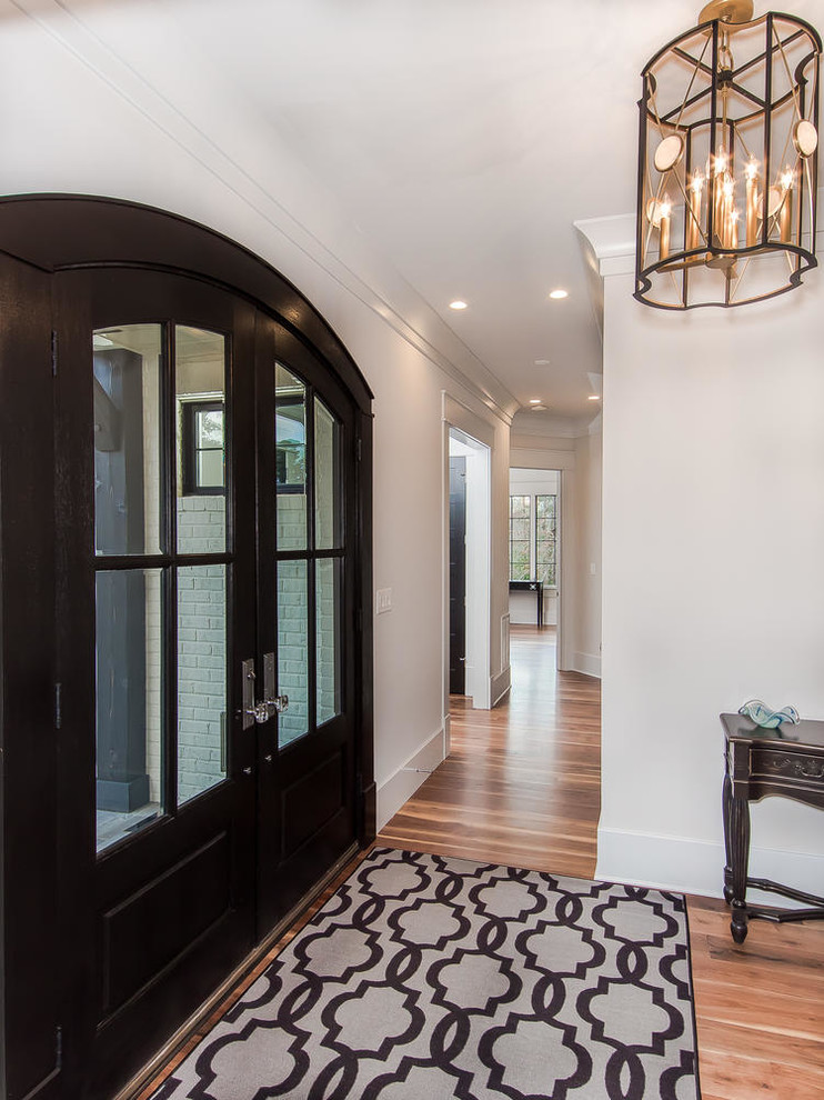 Design ideas for a mid-sized traditional entry hall in Raleigh with white walls, light hardwood floors, a double front door and a dark wood front door.