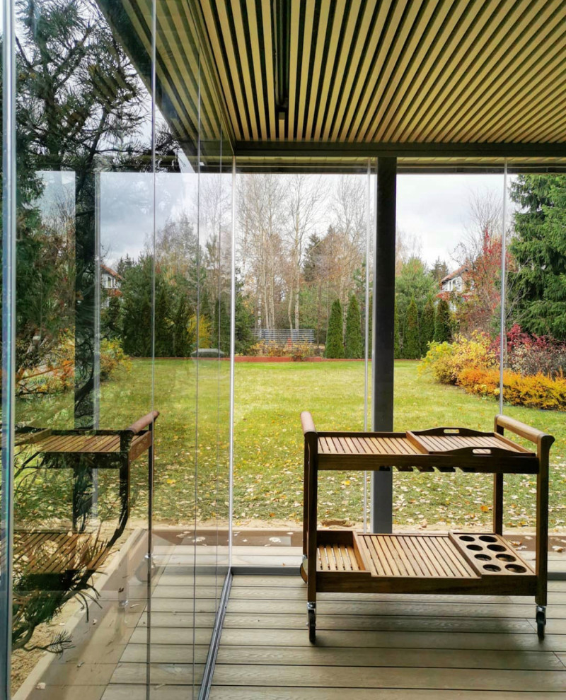 This is an example of a medium sized contemporary courtyard patio in Saint Petersburg with a bbq area and a gazebo.