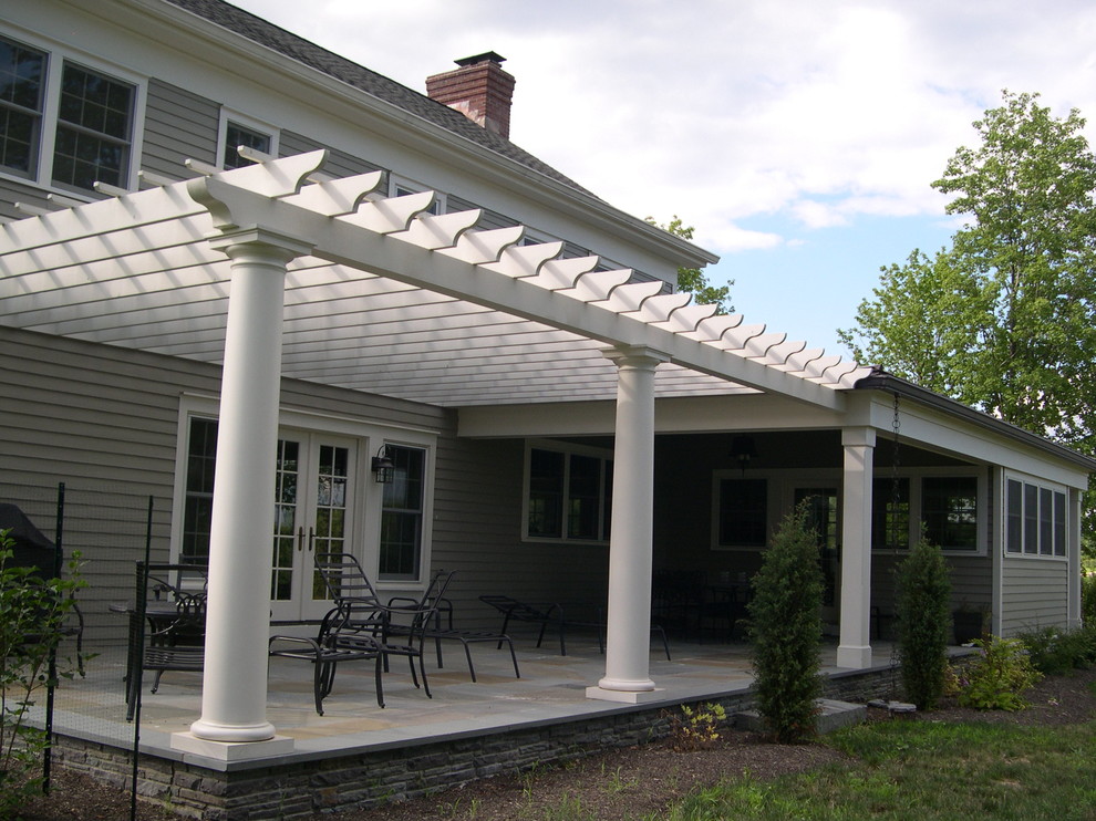 Photo of a mid-sized traditional backyard patio in New York with a pergola.
