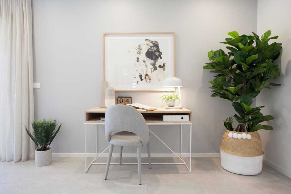 Contemporary home office in Melbourne with grey walls, a freestanding desk and beige floor.