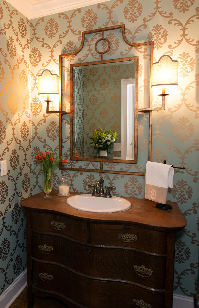 Mid-sized traditional powder room in Atlanta with a drop-in sink, furniture-like cabinets, wood benchtops, a two-piece toilet, dark wood cabinets and brown benchtops.