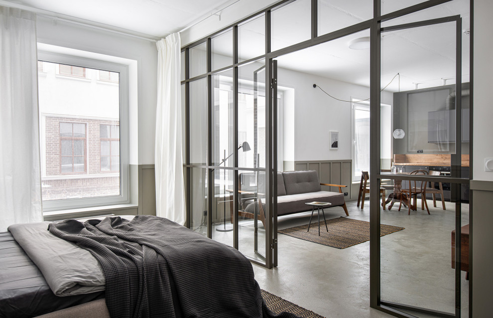 Idee per una piccola camera da letto con pareti bianche, pavimento in cemento, pavimento grigio e pannellatura