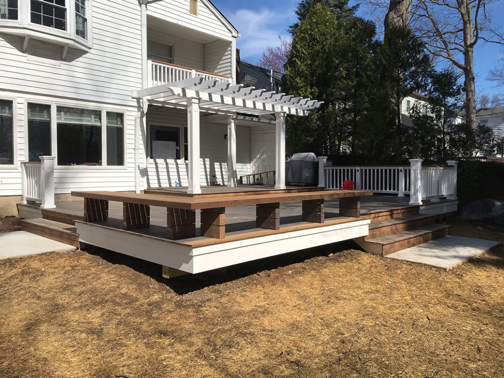 This is an example of an expansive transitional backyard deck in Other with with dock and a pergola.