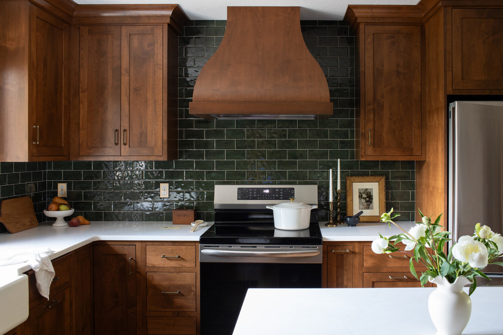 Kitchen pantry - mid-sized transitional l-shaped medium tone wood floor and brown floor kitchen pantry idea with a farmhouse sink, shaker cabinets, medium tone wood cabinets, quartz countertops, green backsplash, subway tile backsplash, stainless steel appliances, an island and white countertops