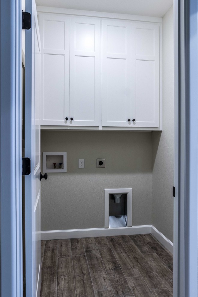 This is an example of a small contemporary single-wall dedicated laundry room in Other with shaker cabinets, white cabinets, beige walls, porcelain floors, a side-by-side washer and dryer and beige floor.