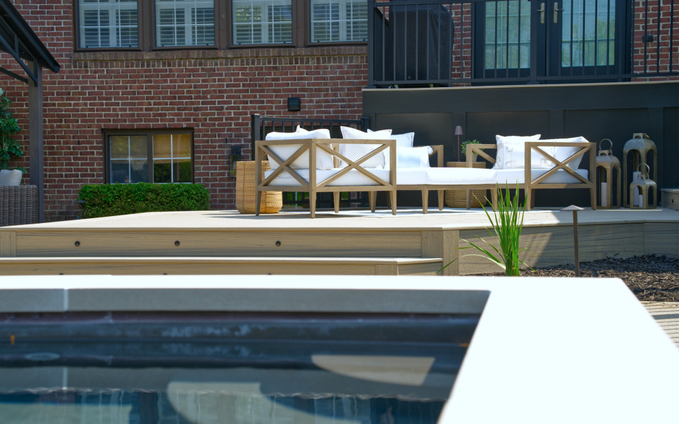 Mid-sized trendy backyard privacy and metal railing deck photo in Detroit