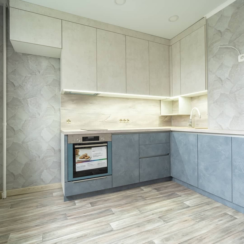Bild på ett mellanstort funkis grå grått kök, med en nedsänkt diskho, luckor med infälld panel, vita skåp, träbänkskiva, grått stänkskydd, stänkskydd i trä, rostfria vitvaror, linoleumgolv och brunt golv