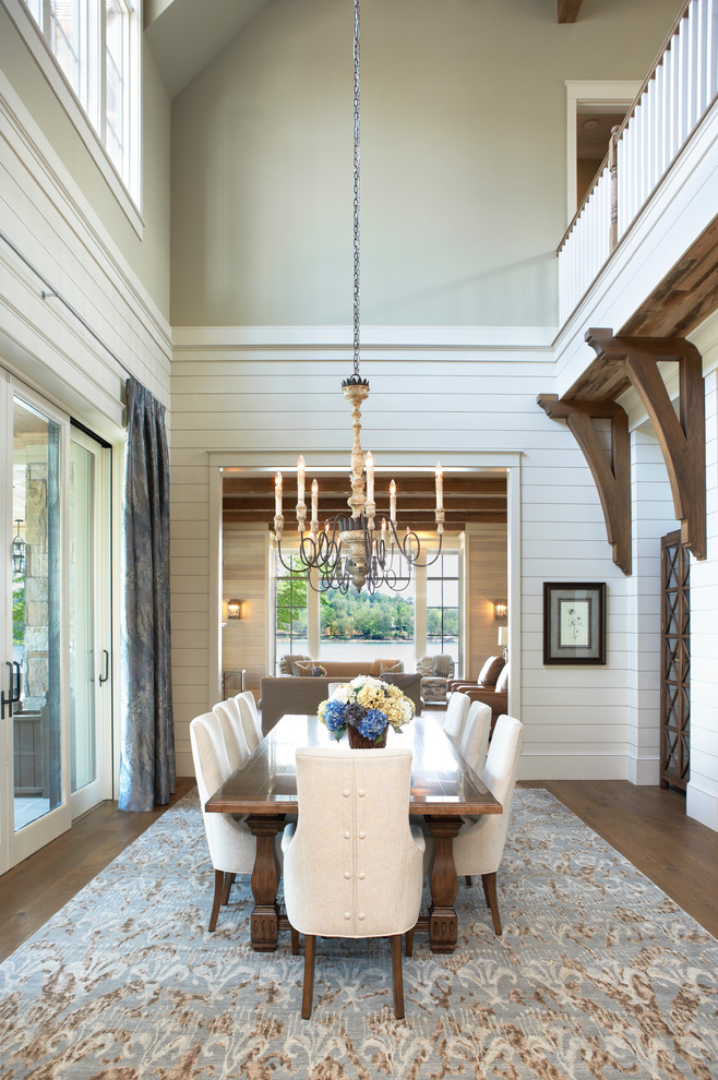 Inspiration for a beach style dining room in Other with white walls, medium hardwood floors and brown floor.