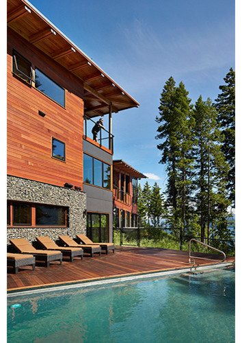 Design ideas for an expansive country three-storey brown exterior in Seattle with wood siding and a flat roof.