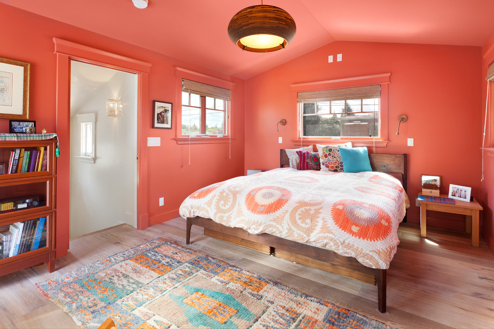 Mid-sized eclectic guest bedroom in San Francisco with orange walls, light hardwood floors, beige floor and no fireplace.
