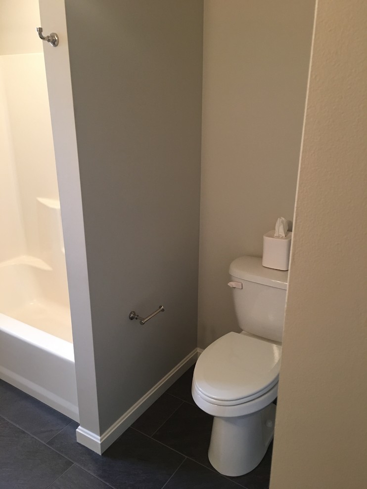 Mid-sized traditional 3/4 bathroom in Other with shaker cabinets, white cabinets, an alcove tub, an alcove shower, porcelain tile, white walls, porcelain floors, an undermount sink, marble benchtops, black floor, a two-piece toilet, white tile and an open shower.