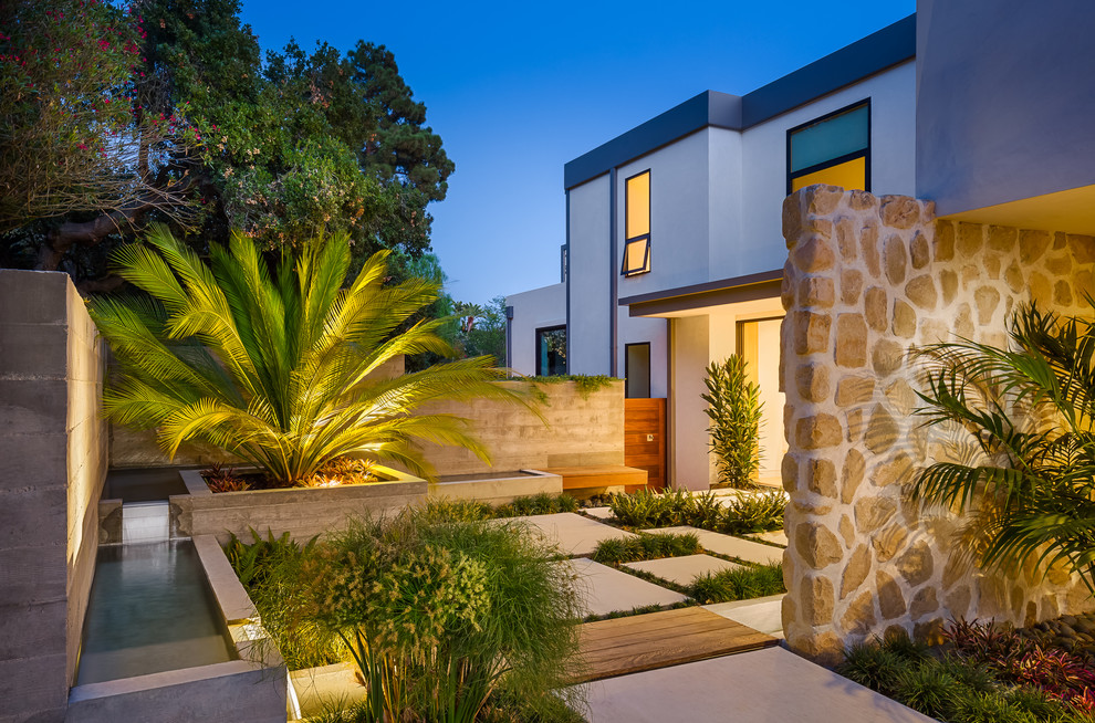 This is an example of a contemporary front yard partial sun garden in Santa Barbara with concrete pavers.