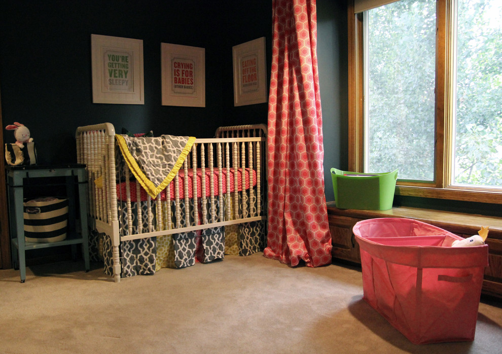 Photo of a mid-sized modern nursery for girls in Omaha with black walls and carpet.