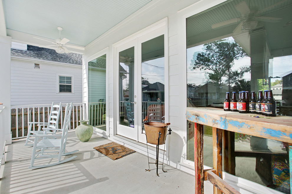 This is an example of a large traditional backyard verandah in New Orleans with a roof extension.