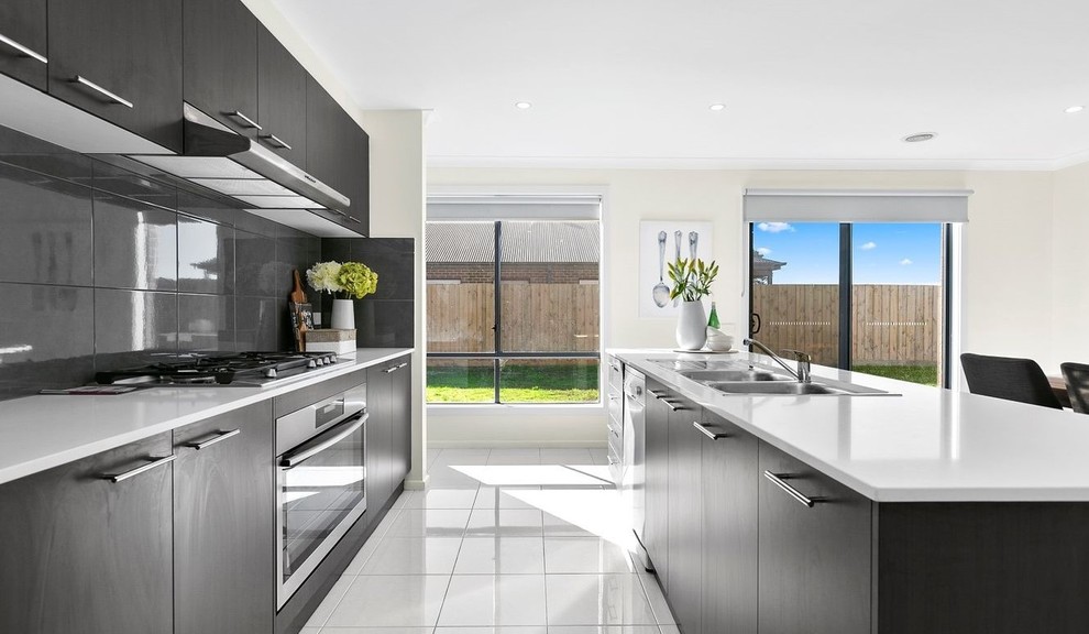 This is an example of a large contemporary single-wall open plan kitchen in Melbourne with with island.