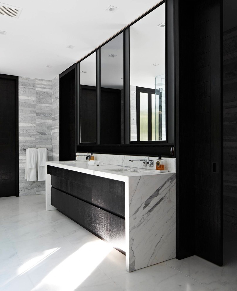 Photo of a large contemporary master bathroom in New York with an undermount sink, flat-panel cabinets, black cabinets, white tile, stone tile, grey walls, linoleum floors and marble benchtops.