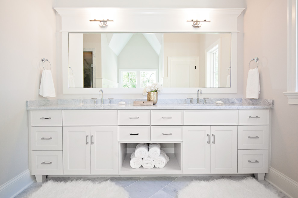 Inspiration for a large contemporary master bathroom in Chicago with an undermount sink, recessed-panel cabinets, white cabinets, gray tile, beige walls, marble floors, marble benchtops and grey benchtops.