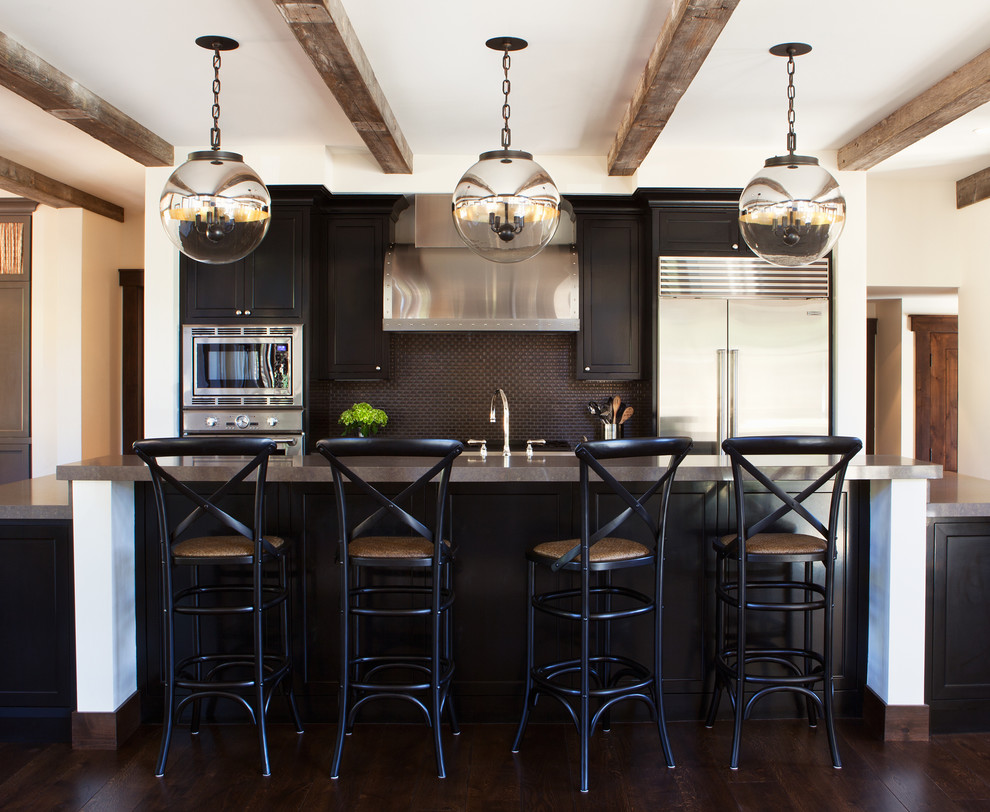 This is an example of a transitional kitchen in San Francisco with black cabinets, black splashback, mosaic tile splashback and with island.