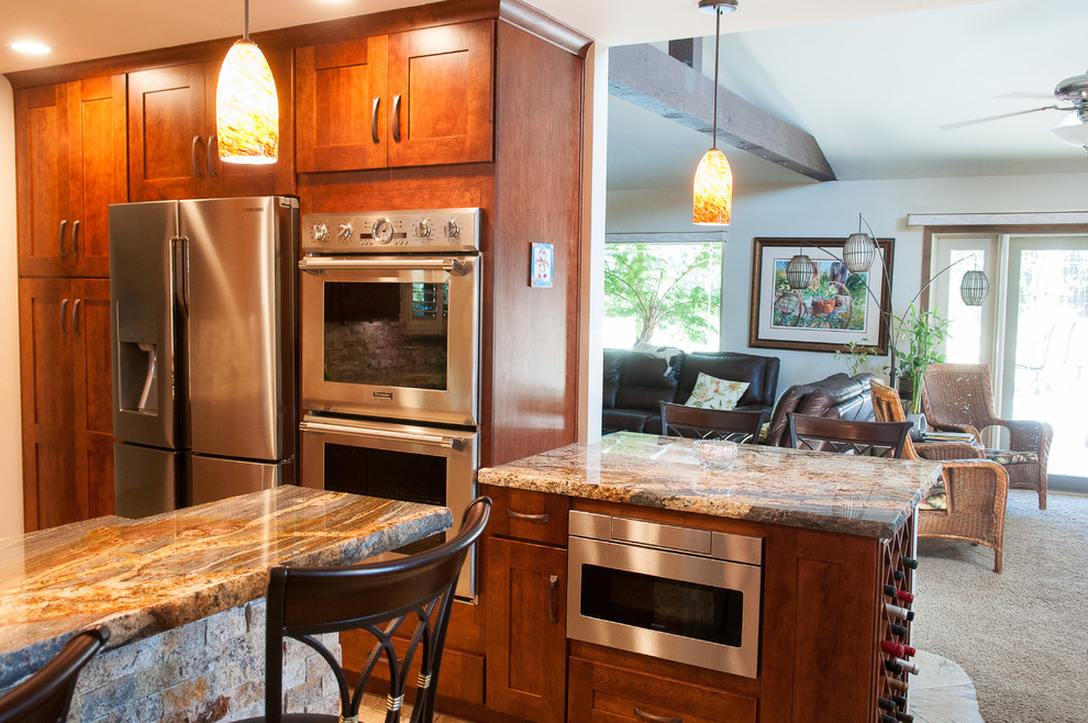 Eat-in kitchen - mid-sized rustic u-shaped slate floor eat-in kitchen idea with an undermount sink, shaker cabinets, dark wood cabinets, granite countertops, beige backsplash, stone tile backsplash, stainless steel appliances and a peninsula