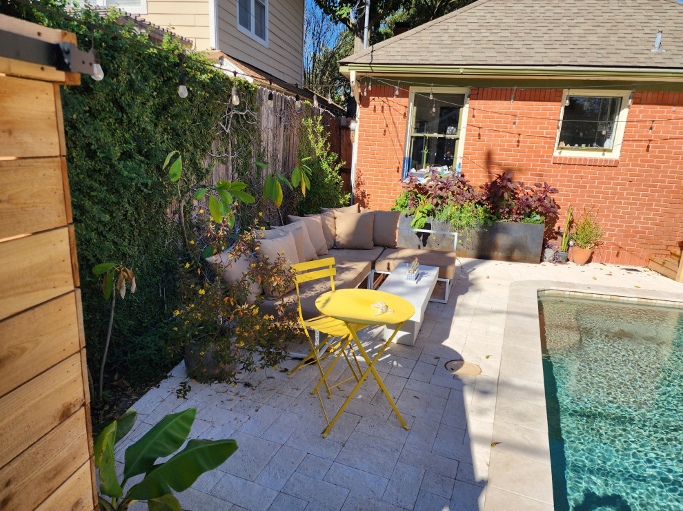 This is an example of a medium sized contemporary back partial sun garden in Houston with concrete paving.