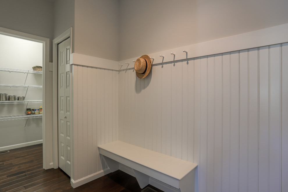 Inspiration for a mid-sized transitional dark wood floor and brown floor foyer remodel with beige walls