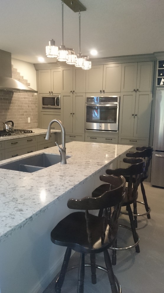 Inspiration for a mid-sized transitional l-shaped porcelain tile eat-in kitchen remodel in Toronto with a double-bowl sink, shaker cabinets, gray cabinets, quartz countertops, multicolored backsplash, porcelain backsplash, stainless steel appliances and an island