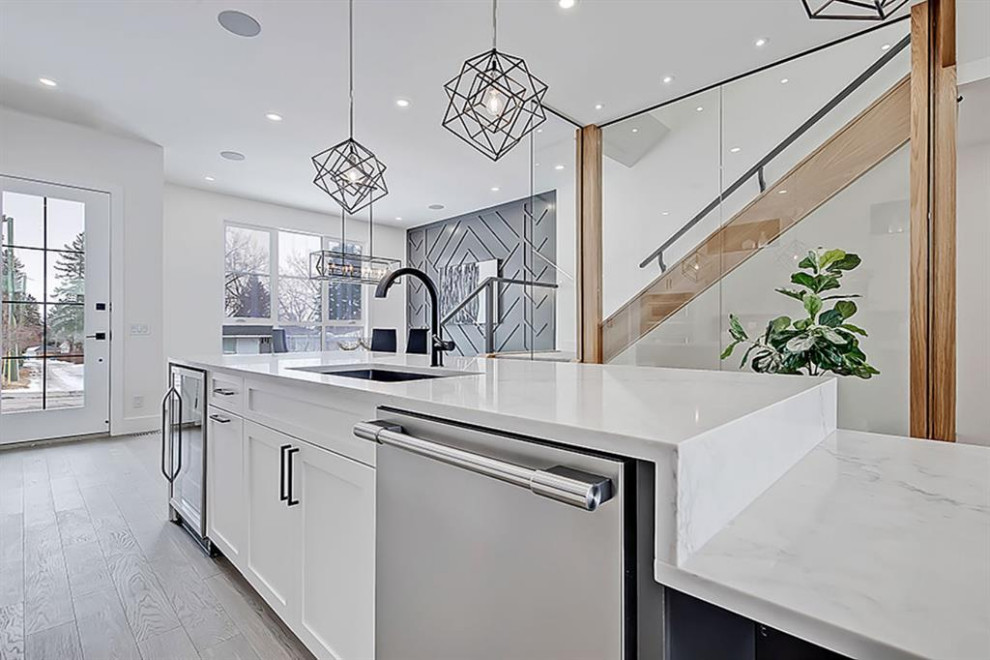 Example of a transitional home design design in Calgary